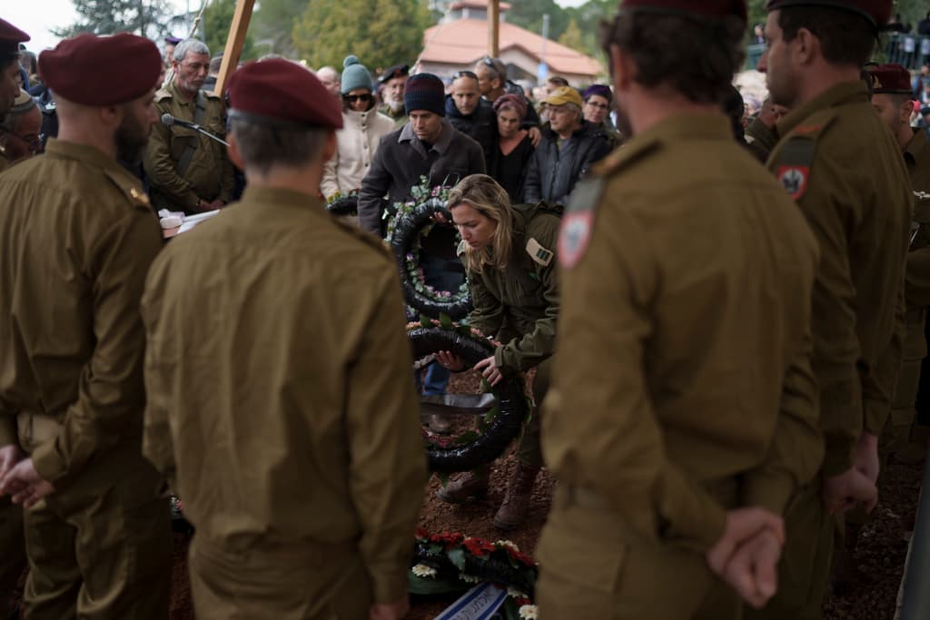 Mourners at the grave of Israeli reservist warrant officer Yuval Nir during his funeral at a cemetery in the West Bank.
